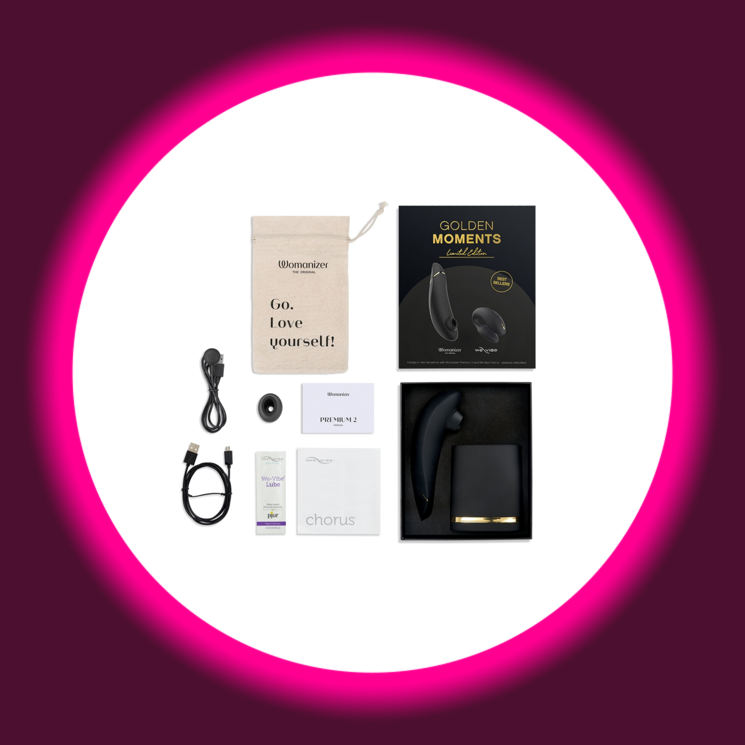 offene schwarze Produktverpackung Womanizer Golden Moments, daneben Beutel, USB-Kabel und Bedienungsanleitung